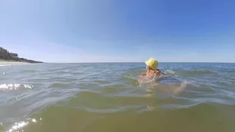 Sexy redhead MILF with big tits has kinky fun at public beach.