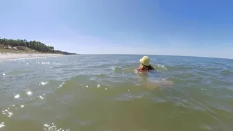 Sexy redhead MILF with big tits has kinky fun at public beach.