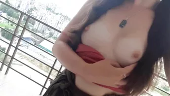 Sultry, Half-Naked Woman Teases From The Balcony