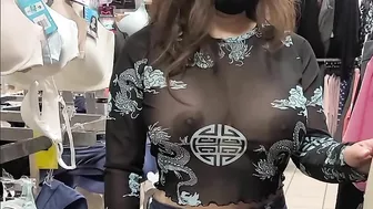 Superb wife with big tits wearing see through blouse in store revealing her nipples