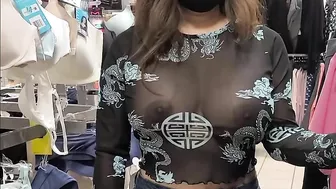 Superb wife with big tits wearing see through blouse in store revealing her nipples