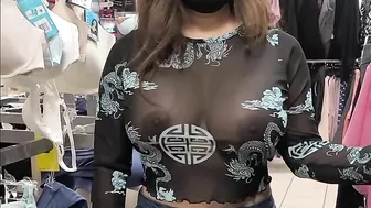 Superb wife with big tits wearing see through blouse in store revealing her nipples