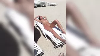 Sultry Woman With Flawless Physique, Shaved Pussy Basks In Beach Sun