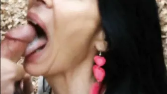 Woman filmed swallowing cock and sperm of young man outdoor