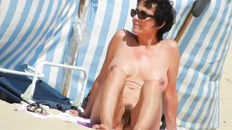 A Mature, Hairy Nudist Woman Enjoys Beach Time With Her Natural Pussy