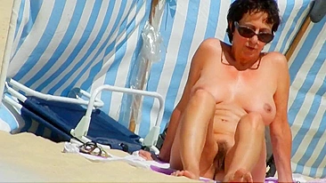 A Mature, Hairy Nudist Woman Enjoys Beach Time With Her Natural Pussy