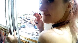 Dude fucking his sexy smoking girlfriend by the window in balcony