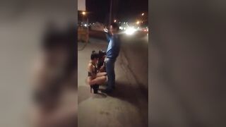 Guy receives blowjob from three women in public place on sidewalk