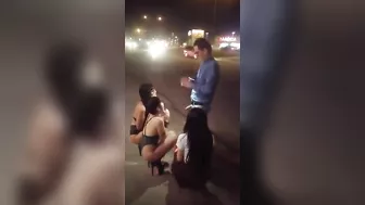 Guy receives blowjob from three women in public place on sidewalk