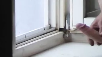 Roommate filming girl giving a handjob to her boyfriend by the window