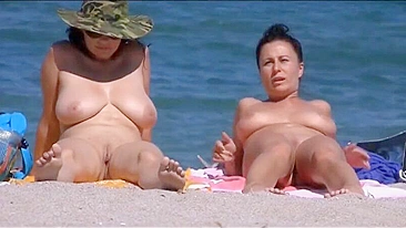 Nudist women with big boobs filmed at the beach