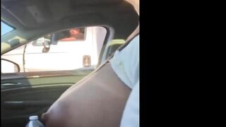 Woman driving topless in car on a public road for everyone to see