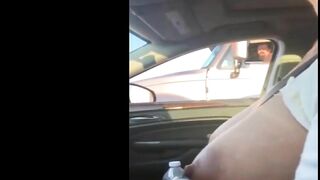 Woman driving topless in car on a public road for everyone to see