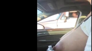 Woman driving topless in car on a public road for everyone to see