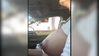 Woman driving topless in car on a public road for everyone to see