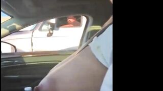 Woman driving topless in car on a public road for everyone to see