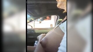 Woman driving topless in car on a public road for everyone to see