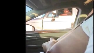 Woman driving topless in car on a public road for everyone to see