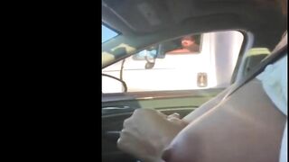 Woman driving topless in car on a public road for everyone to see