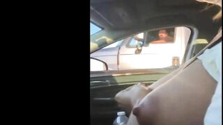 Woman driving topless in car on a public road for everyone to see