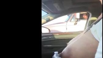 Woman driving topless in car on a public road for everyone to see