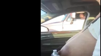 Woman driving topless in car on a public road for everyone to see Woman driving topless in car on a public road for everyone to see