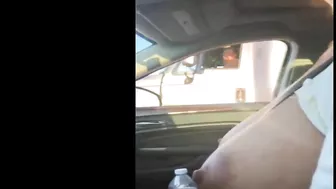 Woman driving topless in car on a public road for everyone to see