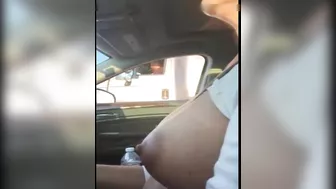 Woman driving topless in car on a public road for everyone to see