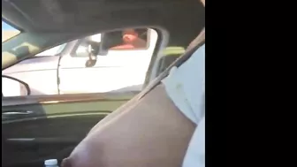 Woman driving topless in car on a public road for everyone to see
