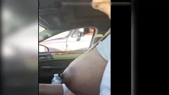Woman driving topless in car on a public road for everyone to see