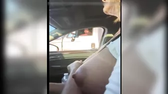 Woman driving topless in car on a public road for everyone to see