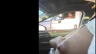 Woman driving topless in car on a public road for everyone to see