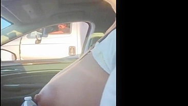 Woman driving topless in car on a public road for everyone to see