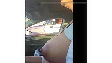 Woman driving topless in car on a public road for everyone to see