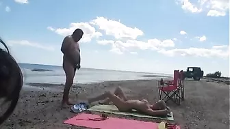 Nudist wife jerks off strangers at the beach and they cum on her Nudist wife jerks off strangers at the beach and they cum on her