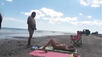 Nudist wife jerks off strangers at the beach and they cum on her