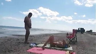 Nudist wife jerks off strangers at the beach and they cum on her
