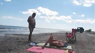 Nudist wife jerks off strangers at the beach and they cum on her