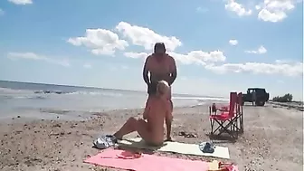 Nudist wife jerks off strangers at the beach and they cum on her