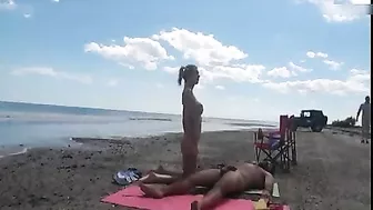 Nudist wife jerks off strangers at the beach and they cum on her