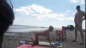Nudist wife jerks off strangers at the beach and they cum on her