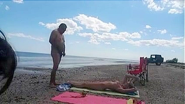 Nudist wife jerks off strangers at the beach and they cum on her