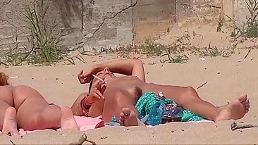 Two nudist girls filmed at the beach voyeur