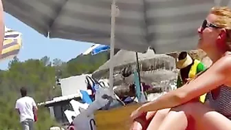 Sun-Kissed, Bikini-Clad Topless Women Tantalize On The Sultry Ibiza Beach