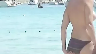 Sun-Kissed, Bikini-Clad Topless Women Tantalize On The Sultry Ibiza Beach