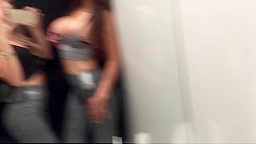 Two horny girls make out in dressing room at mall