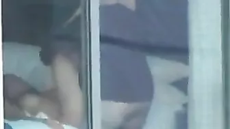 Voyeur sex couple caught fucking by the window - real public exposure and fucking in public video.