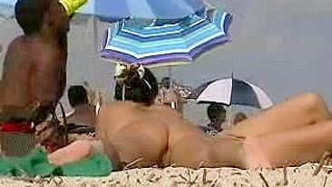 Naked black man with white women at the beach