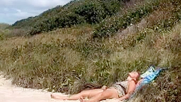 Sultry Woman Filmed At The Beach Masturbating