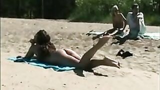 At The Beach, A Sexy, Naked Pussy Is Filmed